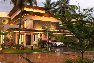 Modern two-story house with warm exterior lighting, palm trees, and a white car parked in the driveway on a wet, reflective pavement at dusk.